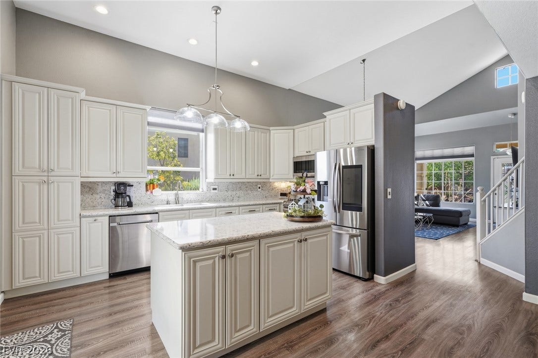 206 Oleander Place, Henderson, NV 89015 Culinary dreams come to life in this kitchen, featuring an inviting island and elegant appliances.