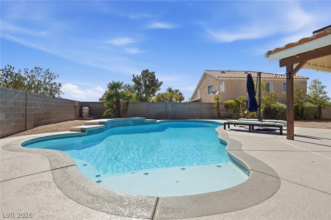 206 Oleander Place, Henderson, NV 89015 An inviting backyard oasis features an in-ground pool, perfect for leisure under a brilliant sky.