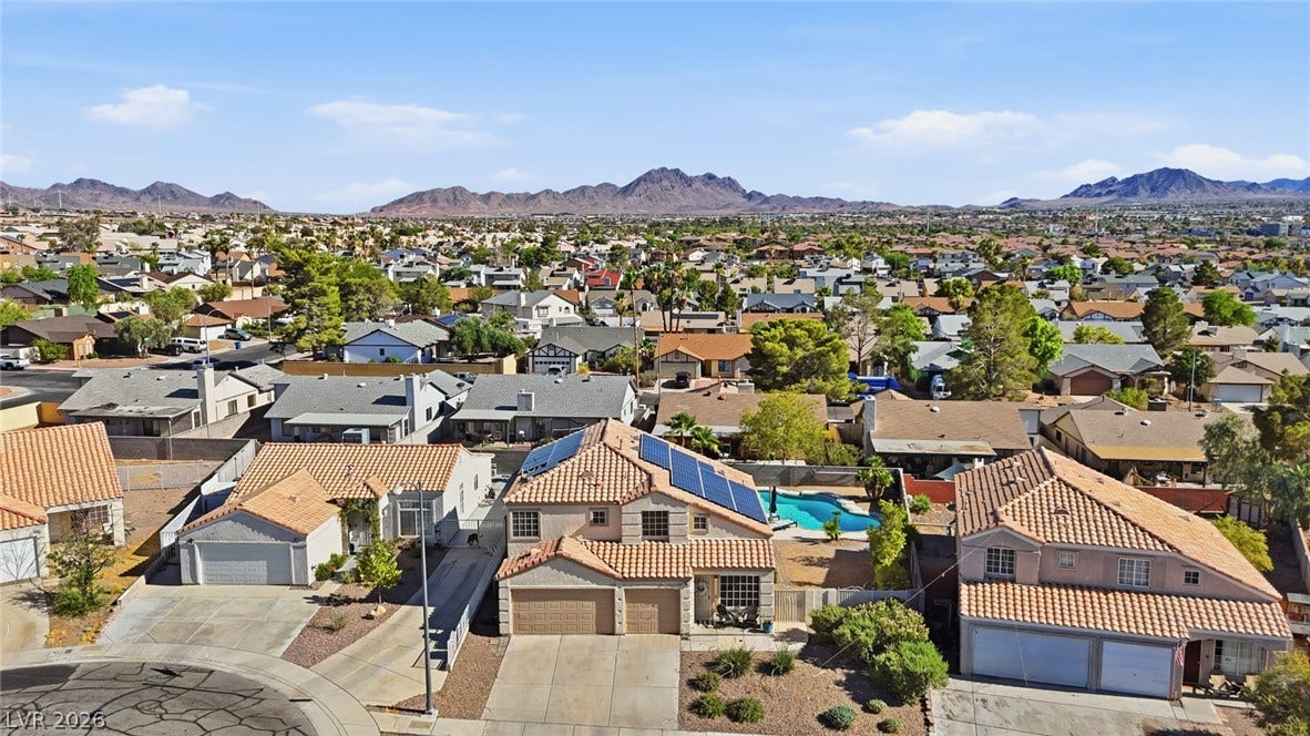 206 Oleander Place, Henderson, NV 89015 An aerial perspective reveals a well-maintained neighborhood with a beautiful pool and mountain views.
