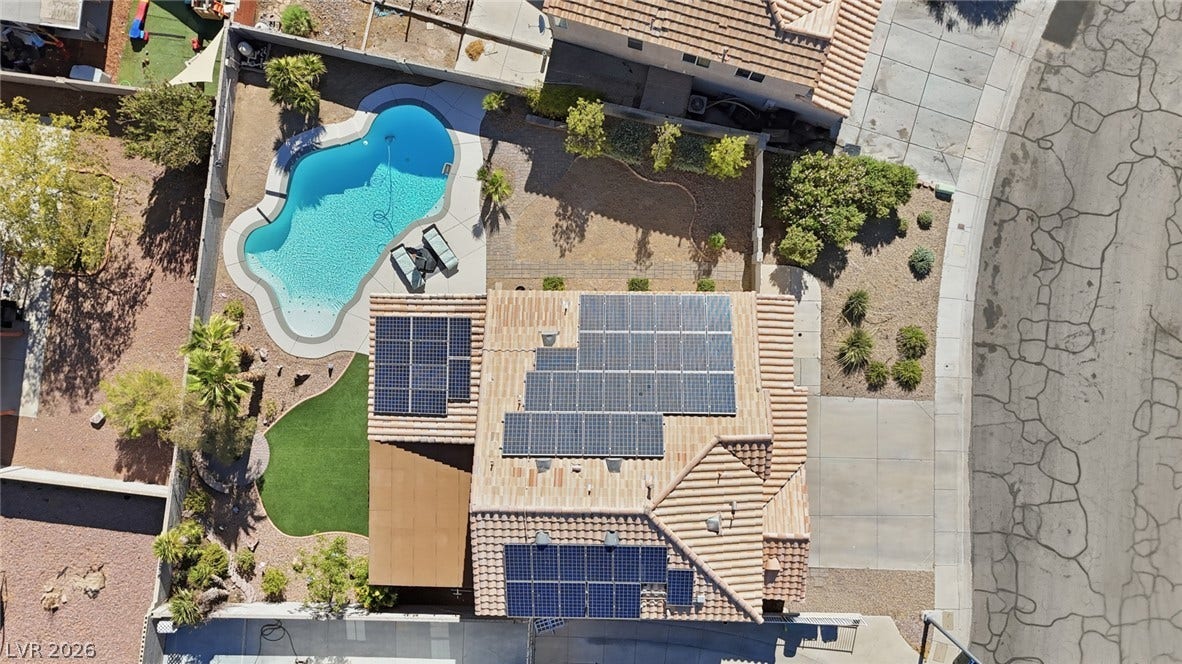 206 Oleander Place, Henderson, NV 89015 An aerial perspective reveals a private pool oasis with desert landscaping and rooftop solar panels.