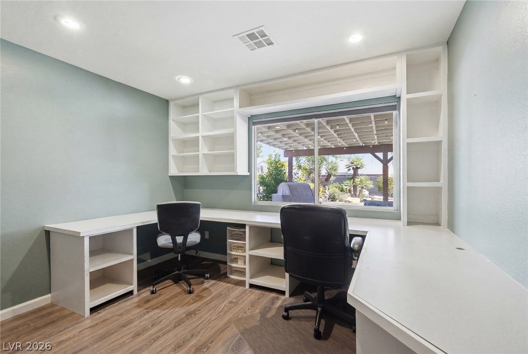 206 Oleander Place, Henderson, NV 89015 Built-in desks and shelving create an efficient and organized home office space.