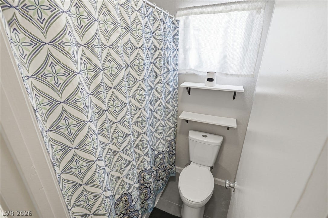 206 Oleander Place, Henderson, NV 89015 Functional full bathroom with contemporary shelving and a window for natural light.