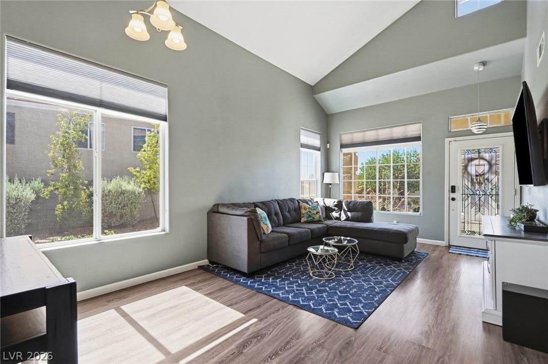 206 Oleander Place, Henderson, NV 89015 Natural light floods this living area, highlighting vaulted ceilings and rich wood flooring.