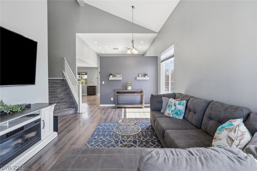 206 Oleander Place, Henderson, NV 89015 Sun-filled living space with vaulted ceilings and beautiful wood flooring.