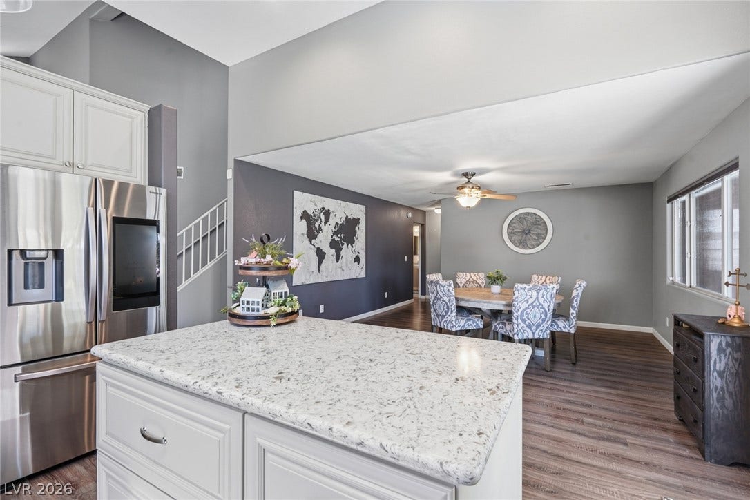 206 Oleander Place, Henderson, NV 89015 Granite counters and stainless steel appliances complete this open-concept kitchen, flowing into a comfortable dining area.