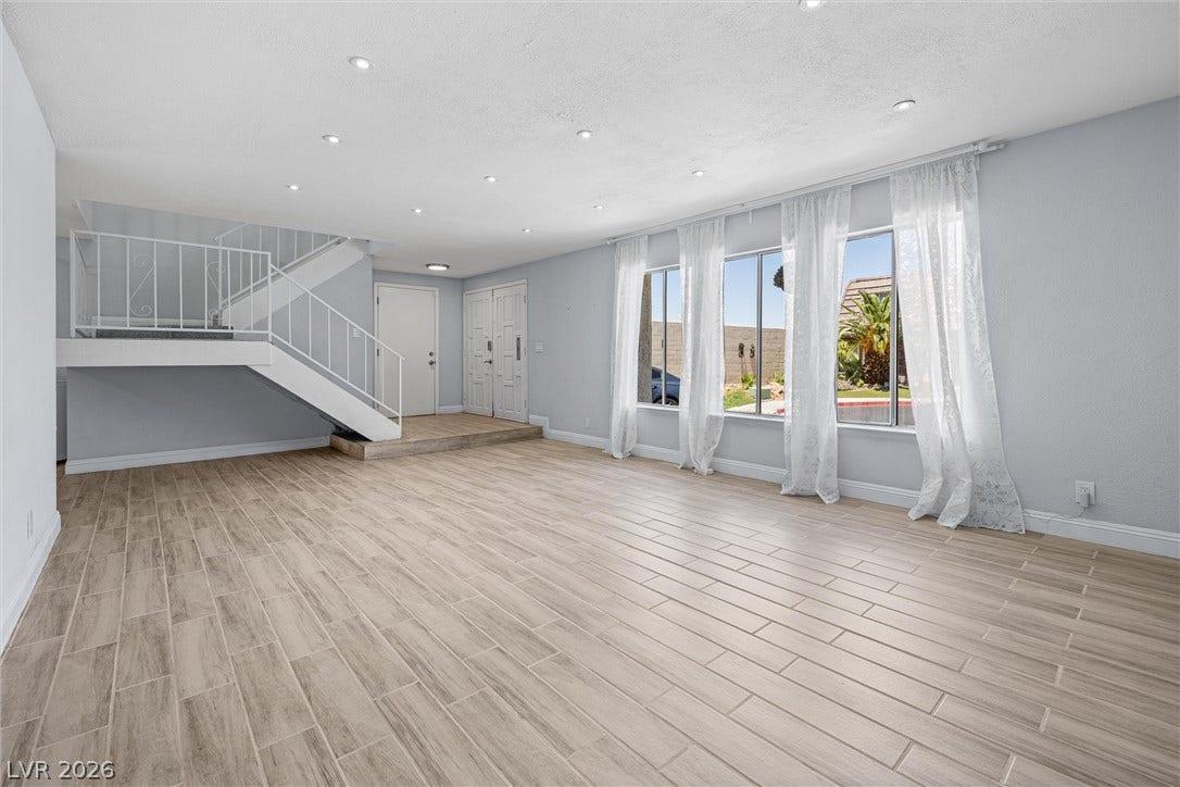 3303 Royce Court, Las Vegas, NV 89121 A spacious living area with sleek tile flooring and ample natural light invites comfortable living.