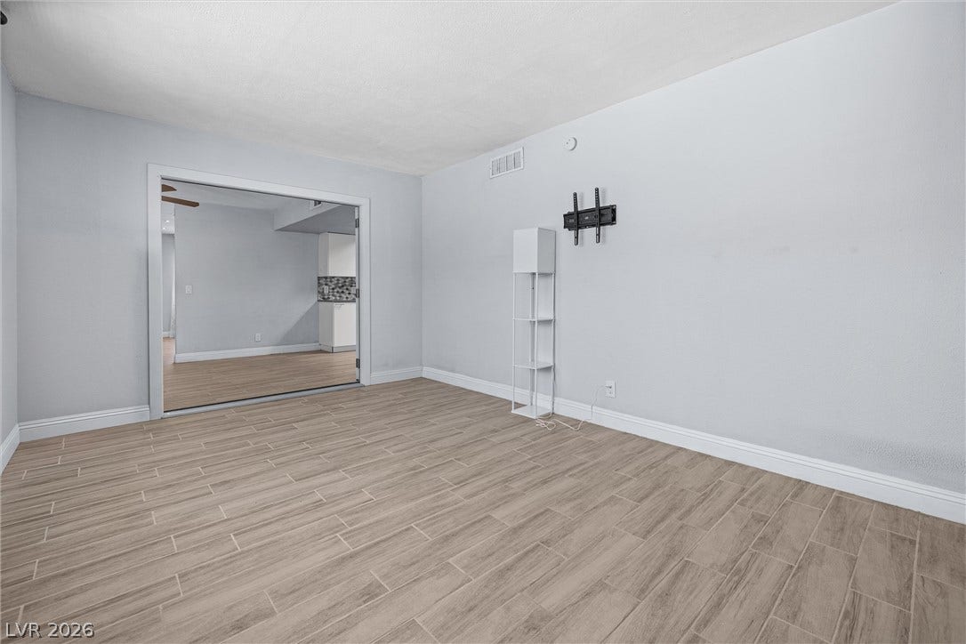 3303 Royce Court, Las Vegas, NV 89121 Hardwood-look tile flooring flows throughout this adaptable space, offering a clean, contemporary foundation.