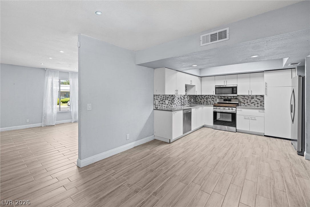 3303 Royce Court, Las Vegas, NV 89121 A well-appointed kitchen showcasing contemporary cabinetry and resilient tile flooring.