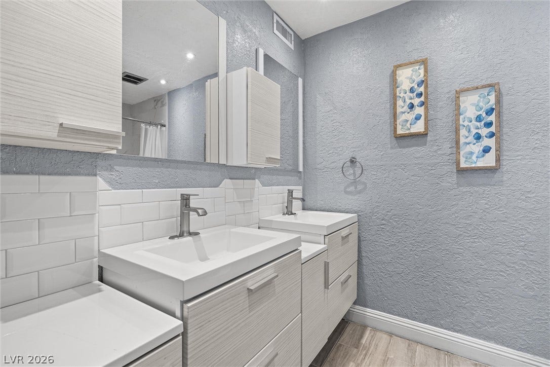 3303 Royce Court, Las Vegas, NV 89121 Two individual vanities, each with a single basin, offer practicality and refined styling in this bathroom.