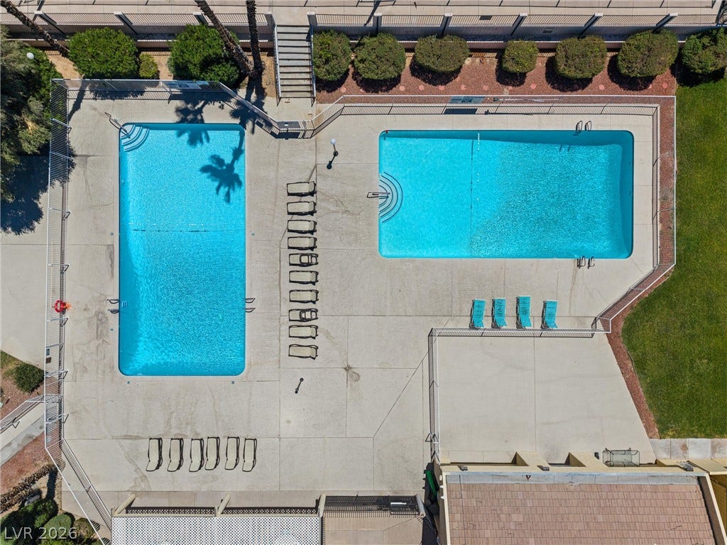 3303 Royce Court, Las Vegas, NV 89121 Dual crystal-blue swimming pools beckon for refreshing dips under the sun.