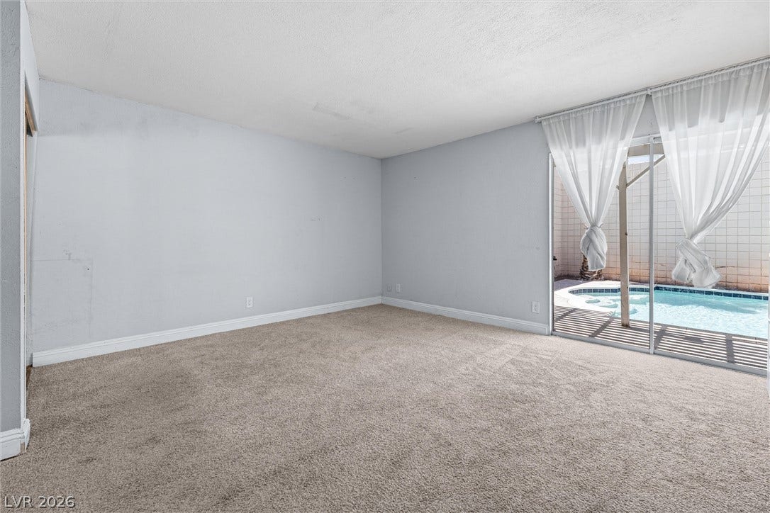 3303 Royce Court, Las Vegas, NV 89121 A spacious room with direct access to a private, sun-drenched pool area.