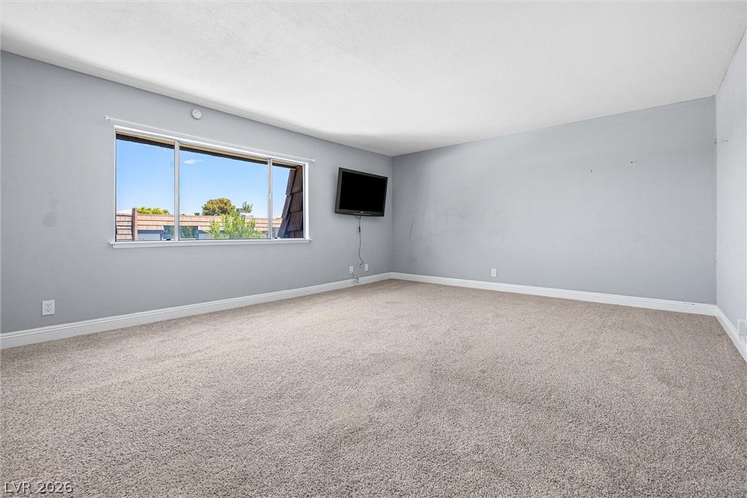 3303 Royce Court, Las Vegas, NV 89121 An airy bedroom with soft carpeting and ample natural light awaits.
