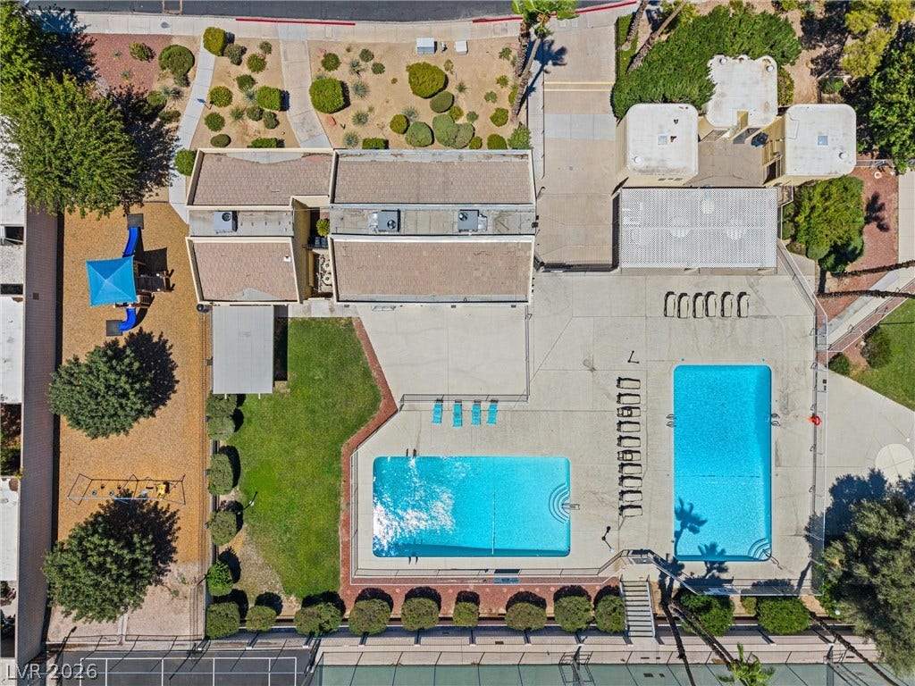 3303 Royce Court, Las Vegas, NV 89121 An aerial perspective reveals a vibrant community with recreational amenities including dual pools and a tennis court.