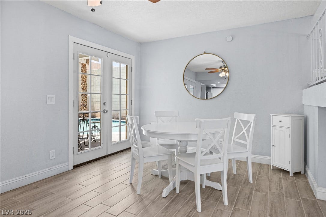 3303 Royce Court, Las Vegas, NV 89121 French doors open to an inviting outdoor space, enhancing this dining area's bright, airy feel.