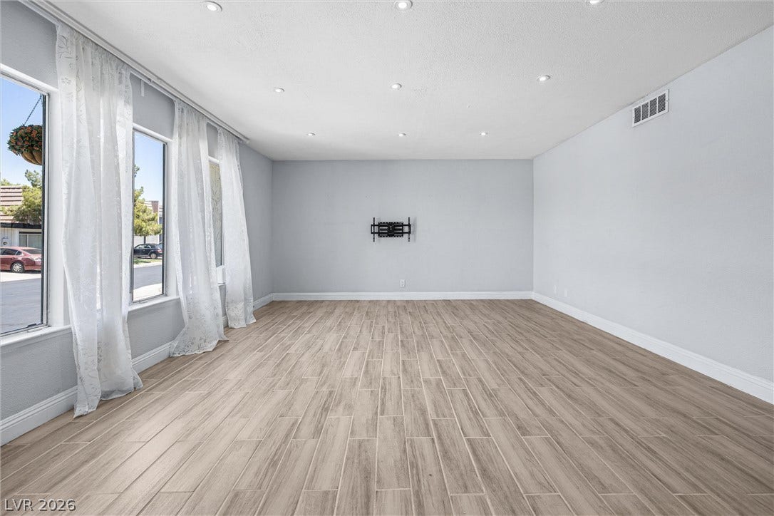 3303 Royce Court, Las Vegas, NV 89121 Well-lit living area featuring recessed lighting and wood-look tile flooring.
