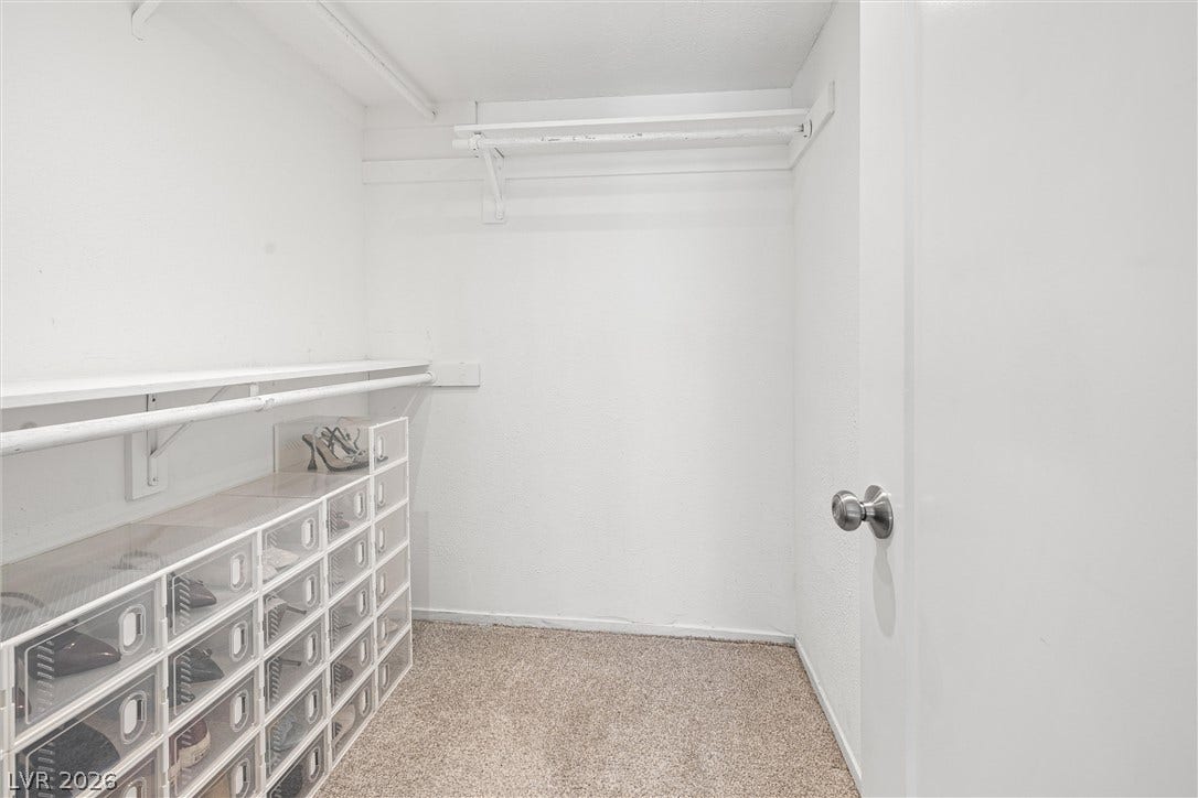 3303 Royce Court, Las Vegas, NV 89121 Functional and tidy, this walk-in closet offers ample storage with shelving and hanging rods.