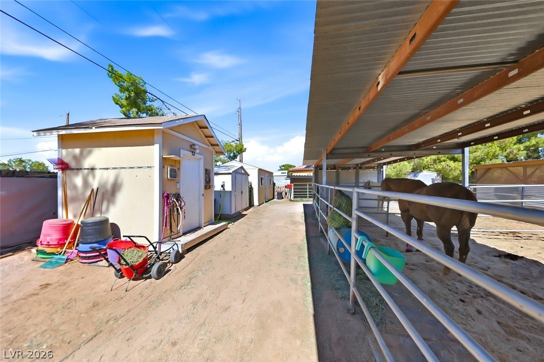 A well-maintained stable and adjacent storage shed provide essential amenities for equestrian enthusiasts.