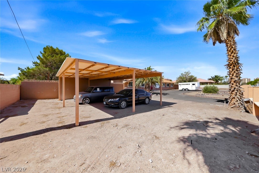 Secure covered parking with ample open space, set against a desert-adapted landscape.