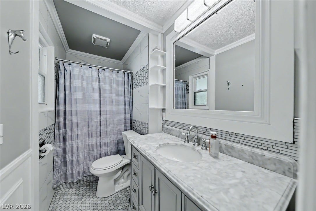 A well-appointed bathroom with marble counters and hexagonal tile flooring offers a pristine and functional space.
