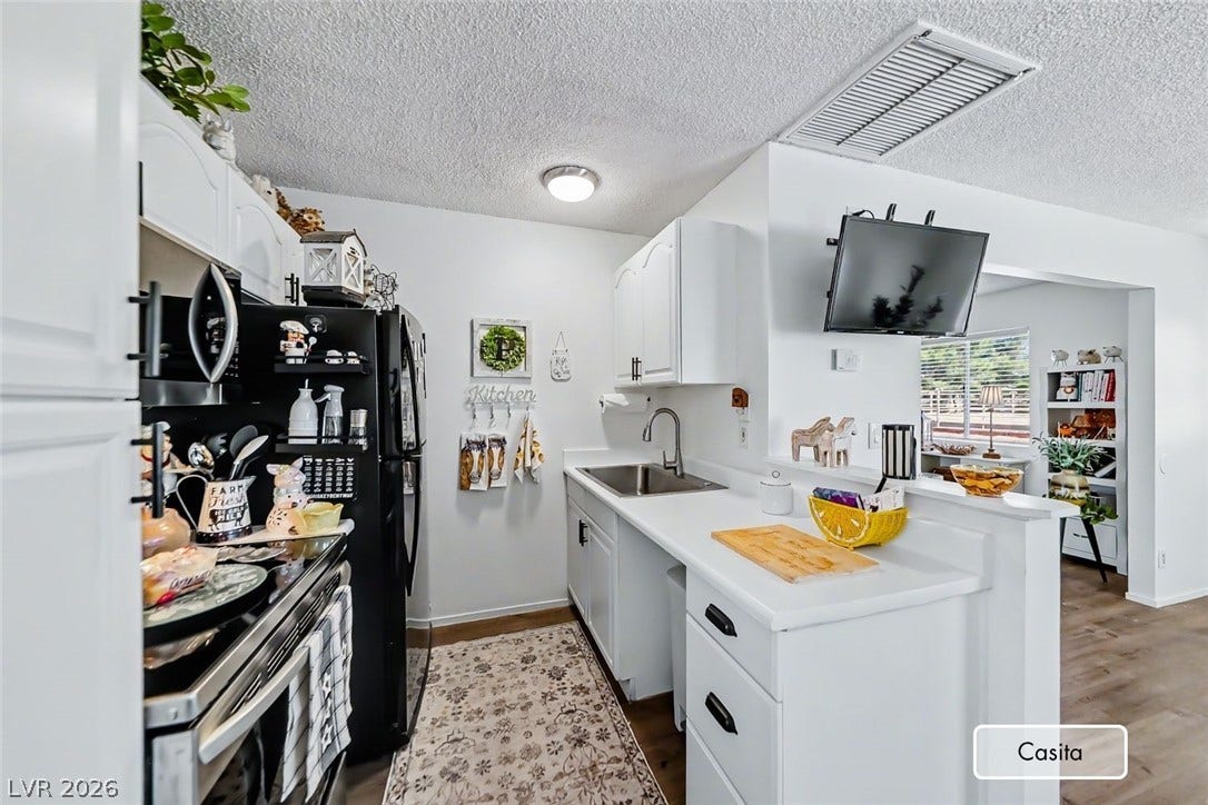 An efficient kitchen layout opens to the adjoining living space.