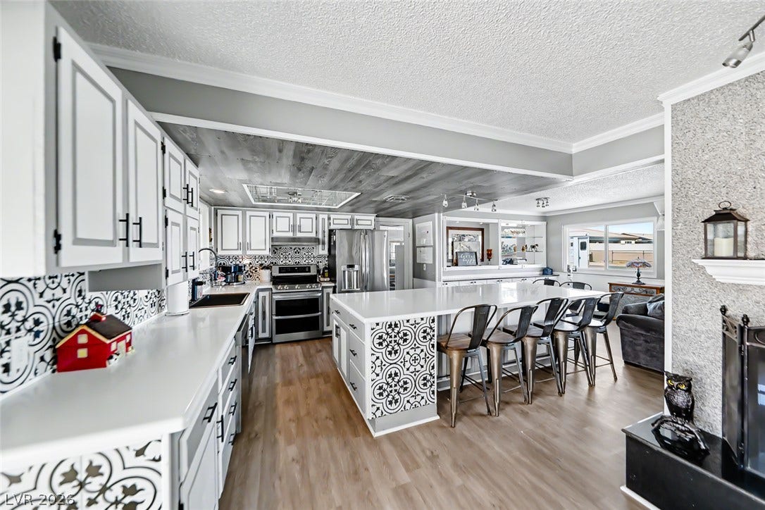 A spacious kitchen with a large island and ample counter space, perfect for entertaining.
