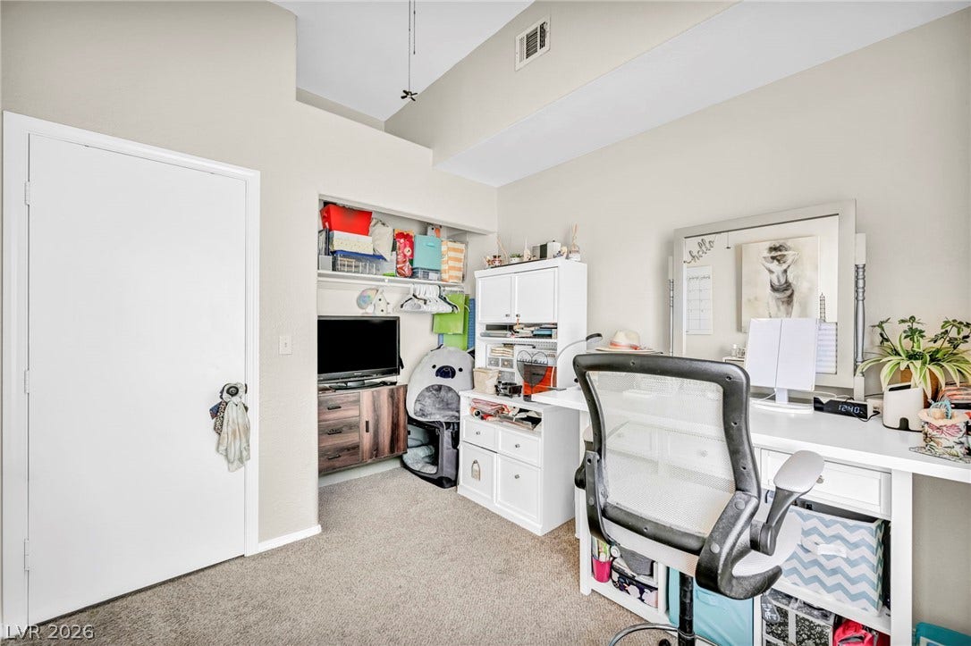 An adaptable interior space featuring high ceilings and practical shelving for diverse living or work arrangements.