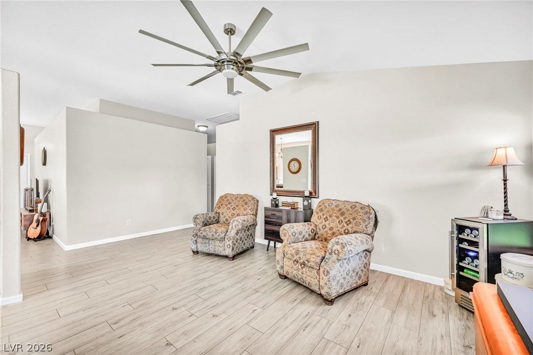 The open living area features vaulted ceilings and light wood flooring, creating an airy and adaptable space.