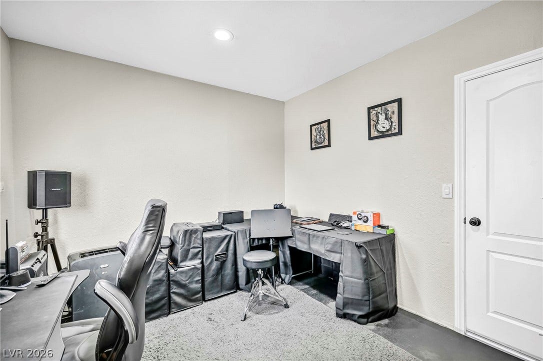 Functional workspace with recessed lighting, offering a dedicated area for productivity and focus.