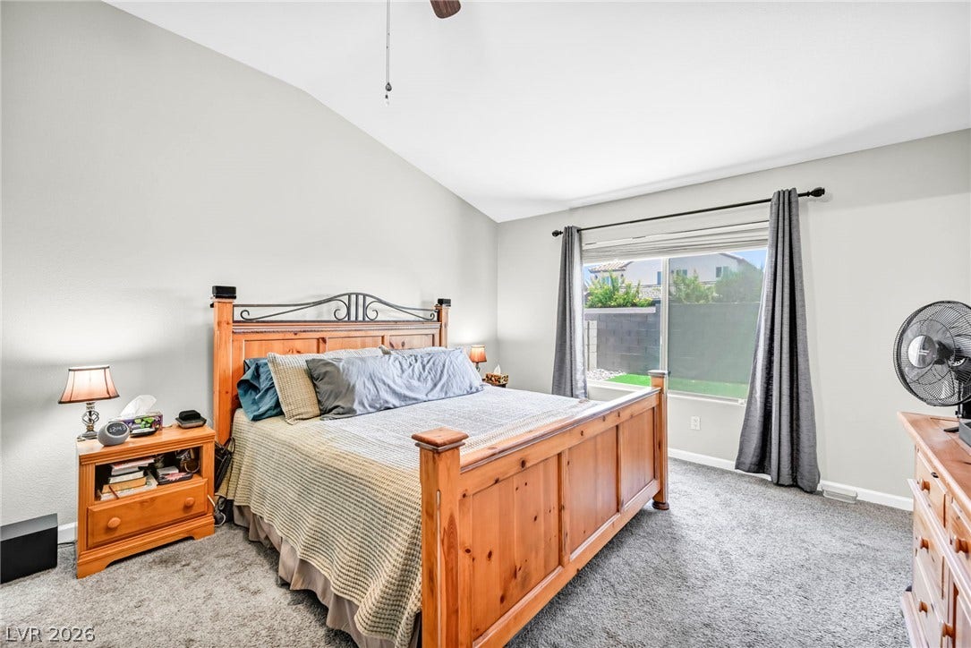 A restful bedroom offers a vaulted ceiling and direct outdoor views.