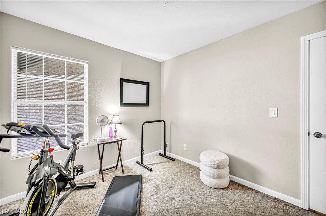 A dedicated home gym space, naturally illuminated, offers convenience for fitness enthusiasts.