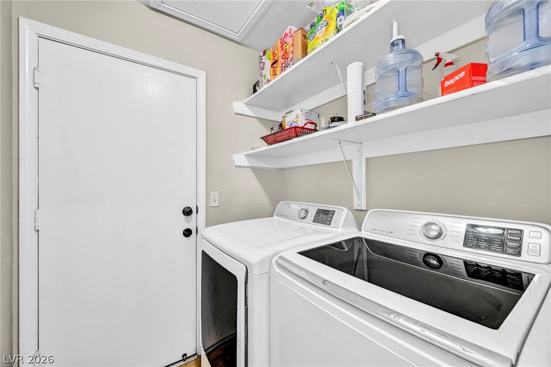 A dedicated laundry room with functional shelving and modern appliances simplifies household tasks.