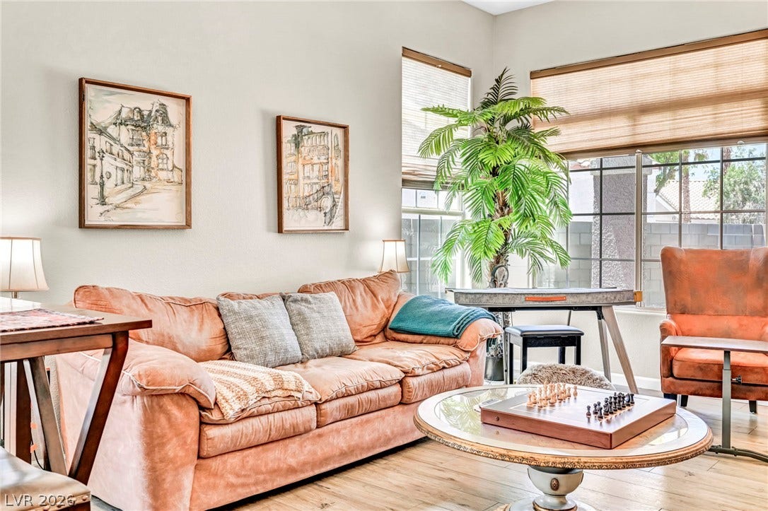 Natural light filters into this inviting living area featuring durable wood flooring and ample window space.