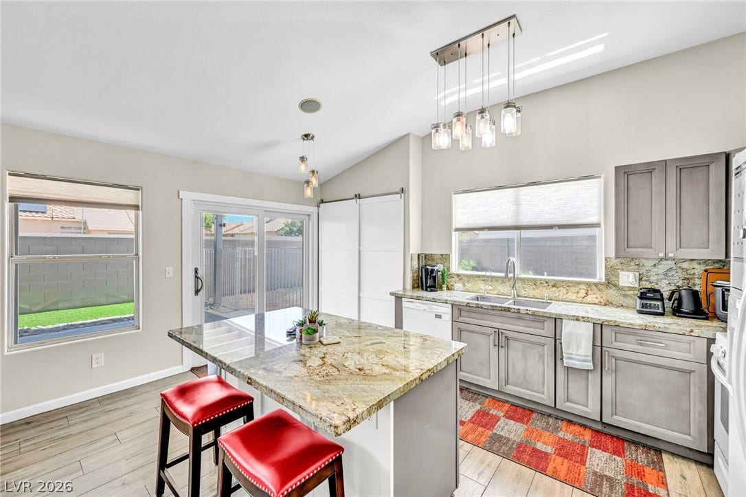 Culinary creations come to life in this kitchen, featuring an inviting island and elegant granite countertops.