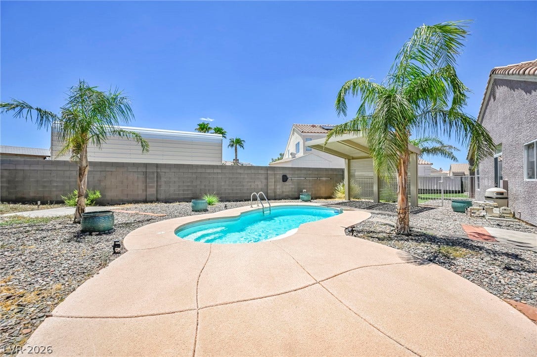 An inviting backyard oasis featuring a freeform pool, perfect for outdoor leisure.
