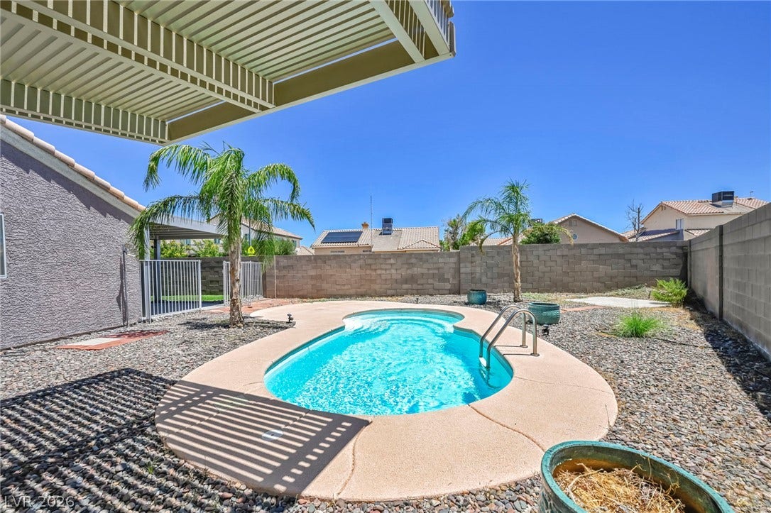 A refreshing pool awaits in this private outdoor retreat, perfect for warm-weather enjoyment.