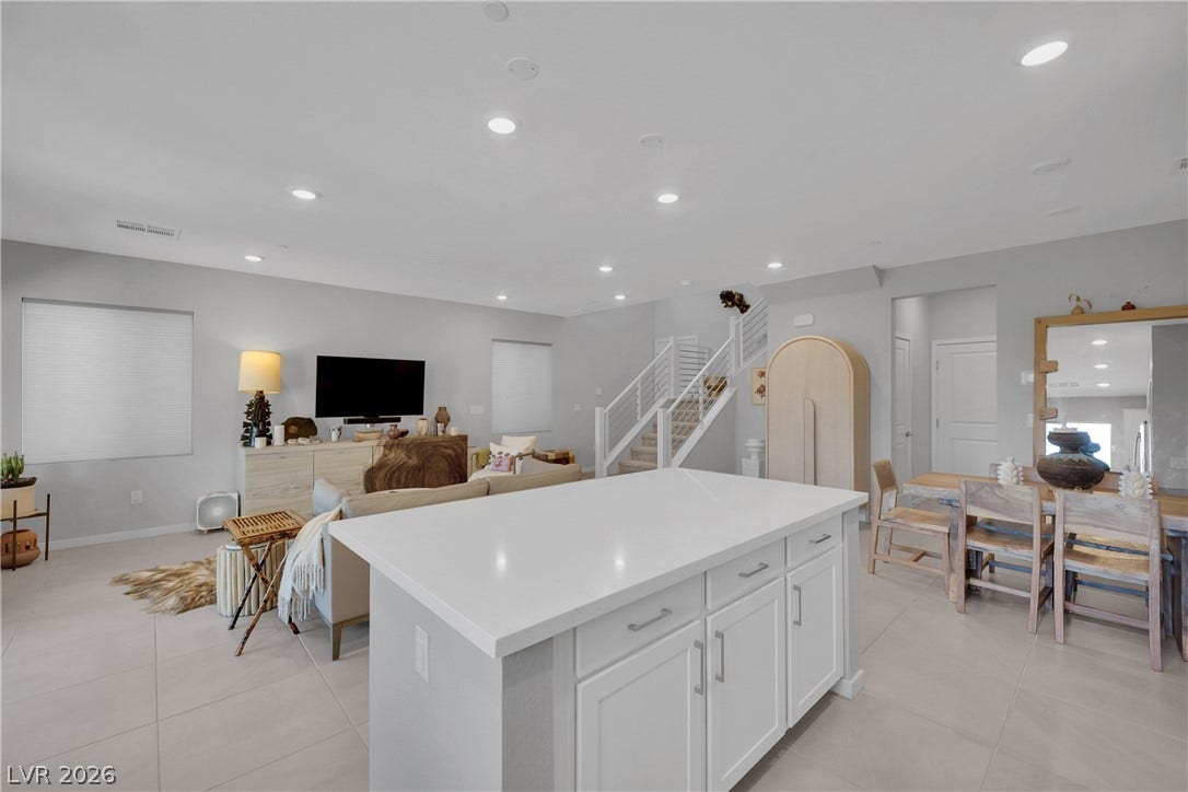 11572 Desert Hollow Avenue, Las Vegas, NV 89138 A luminous living space features an inviting kitchen island and open views to dining and living areas.