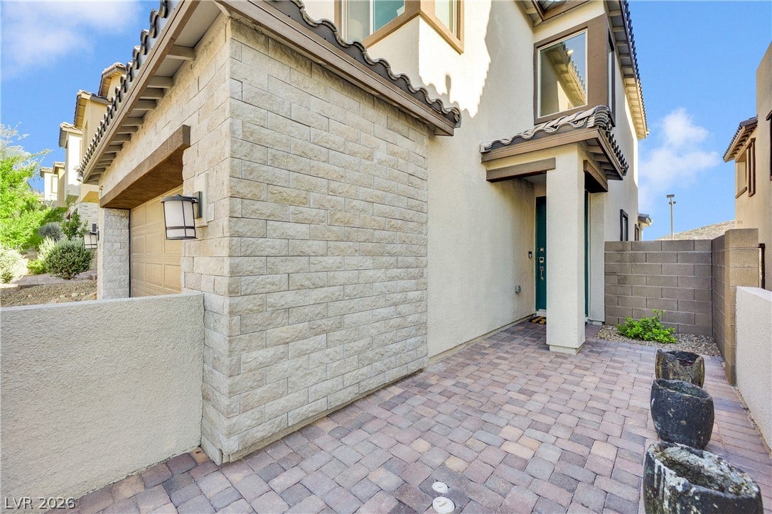 11572 Desert Hollow Avenue, Las Vegas, NV 89138 A welcoming paver walkway leads to the entrance of this modern structure with varied textures.
