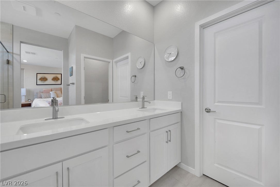 11572 Desert Hollow Avenue, Las Vegas, NV 89138 Double vanities with sleek countertops offer both elegance and convenience.