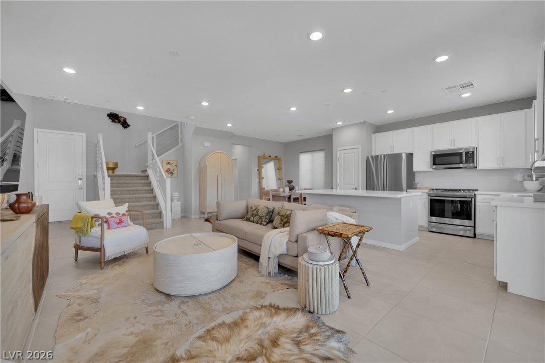 11572 Desert Hollow Avenue, Las Vegas, NV 89138 An open floorplan seamlessly connects the well-lit living area to a pristine kitchen.