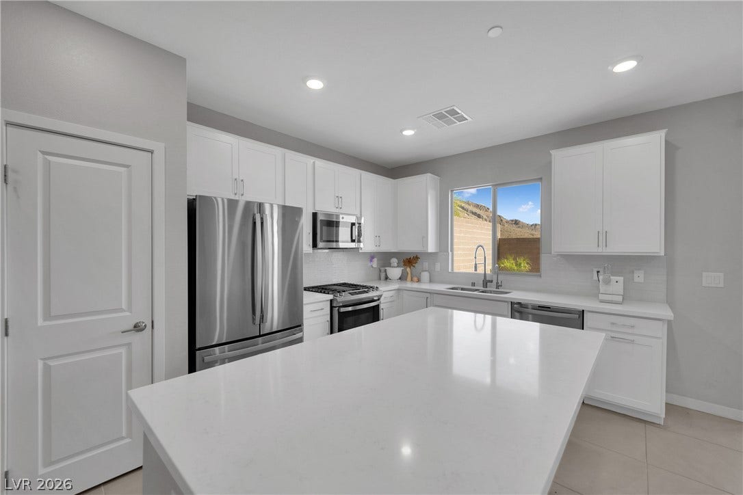 11572 Desert Hollow Avenue, Las Vegas, NV 89138 Culinary dreams come alive in this well-appointed kitchen, boasting stainless steel appliances and abundant counter space.