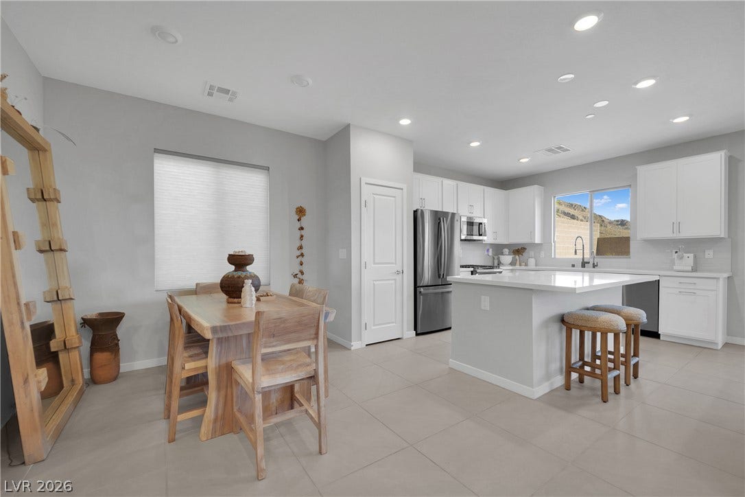 11572 Desert Hollow Avenue, Las Vegas, NV 89138 An open concept kitchen with a central island and a dining area.