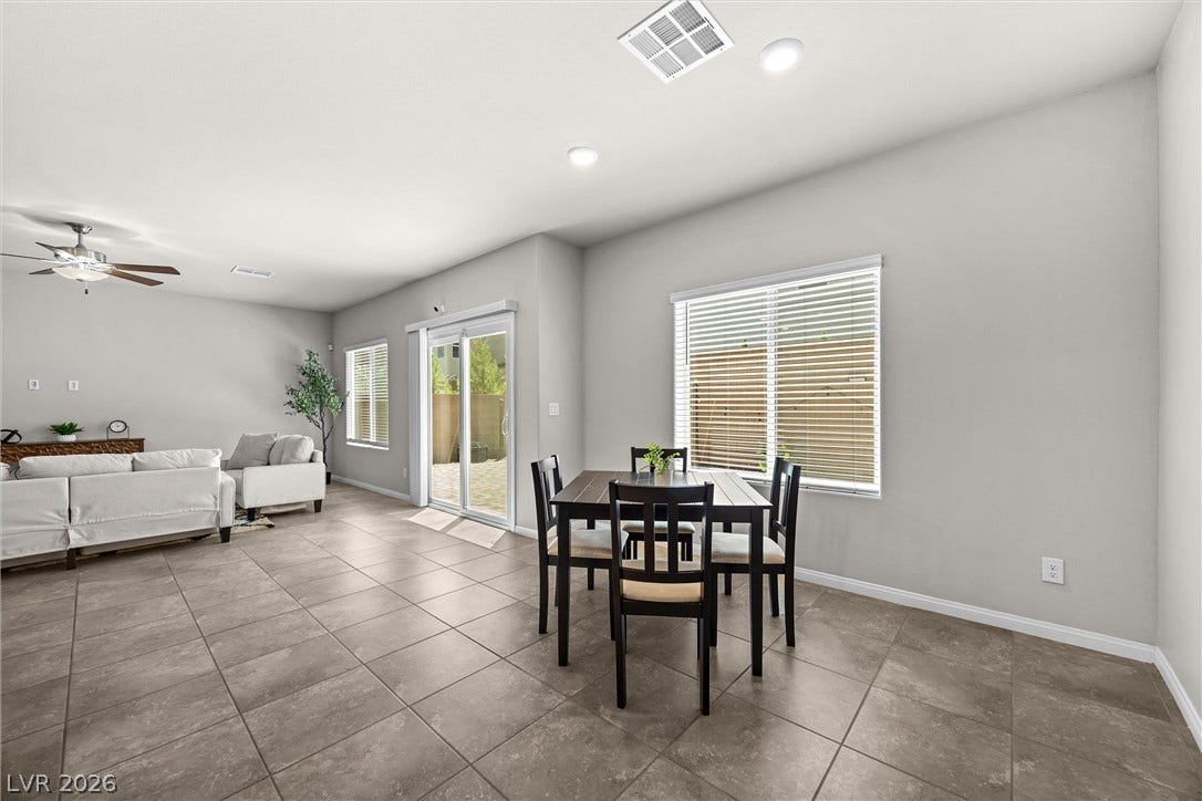 8943 Pelican Point Street, Las Vegas, NV 89178 An open floor plan seamlessly connects the living and dining spaces, featuring recessed lighting and durable tile flooring.