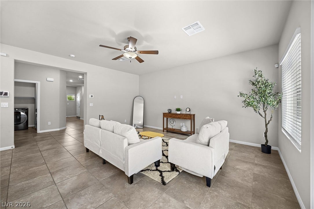 8943 Pelican Point Street, Las Vegas, NV 89178 The open-concept layout of this living space features durable tile flooring and a ceiling fan for optimal comfort.