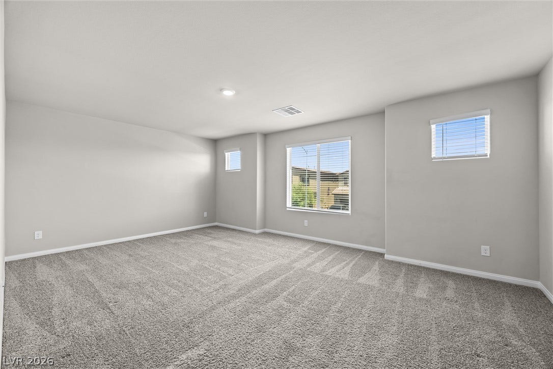 8943 Pelican Point Street, Las Vegas, NV 89178 An airy room awaits with plush carpeting and natural light filtering through multiple windows.