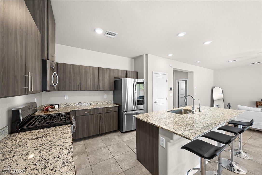 8943 Pelican Point Street, Las Vegas, NV 89178 A well-appointed kitchen showcasing durable granite counters and a practical island for daily routines.