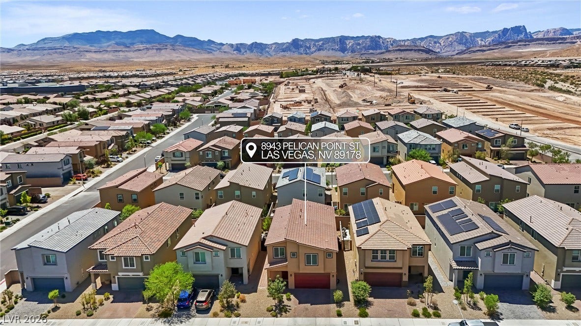8943 Pelican Point Street, Las Vegas, NV 89178 An aerial perspective showcases a vibrant community with desert mountains in the background.