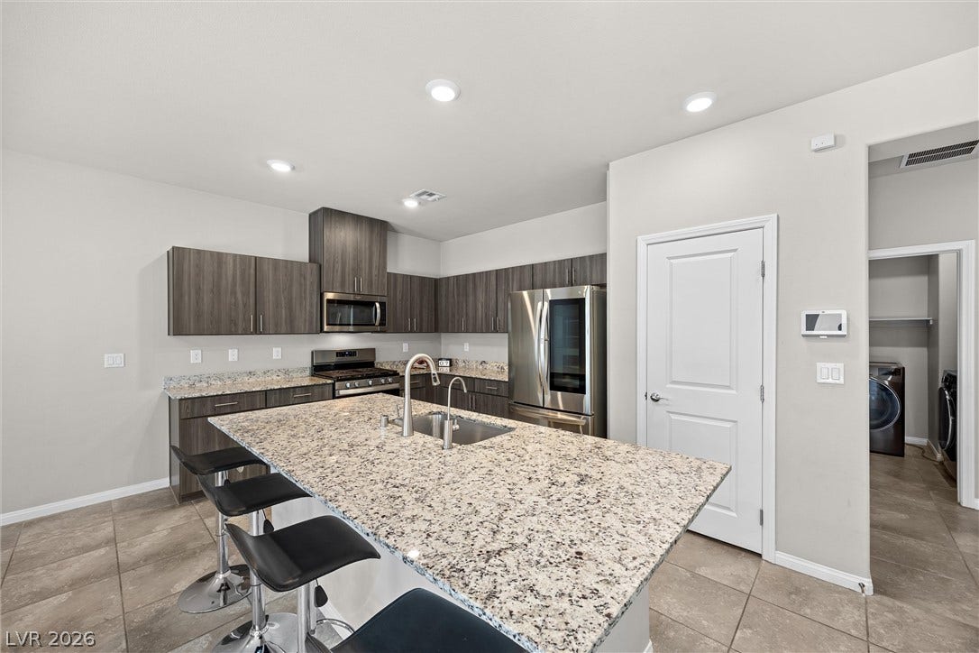 8943 Pelican Point Street, Las Vegas, NV 89178 A well-appointed kitchen showcasing an inviting island with a breakfast bar and modern appliances.