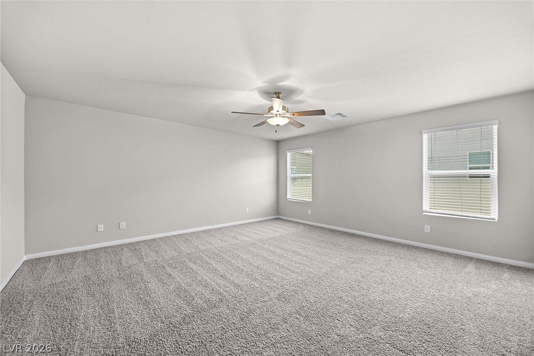 8943 Pelican Point Street, Las Vegas, NV 89178 A spacious, naturally illuminated room features plush carpeting and ceiling fan for comfort.