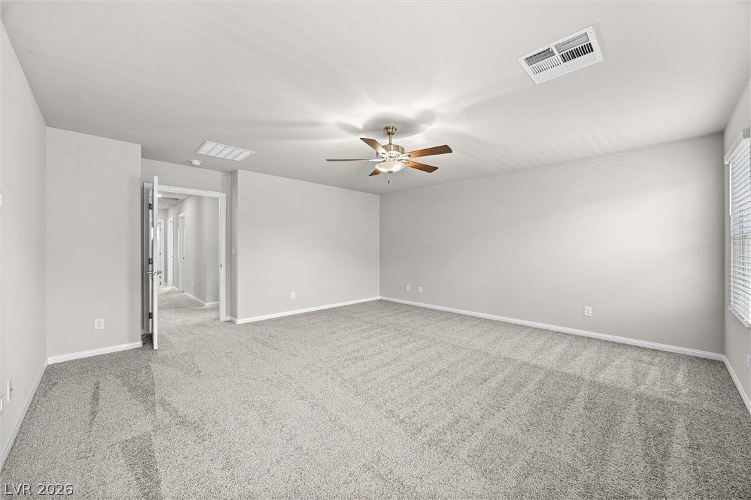 8943 Pelican Point Street, Las Vegas, NV 89178 A spacious, naturally illuminated room boasts soft carpeting and a ceiling fan for year-round comfort.