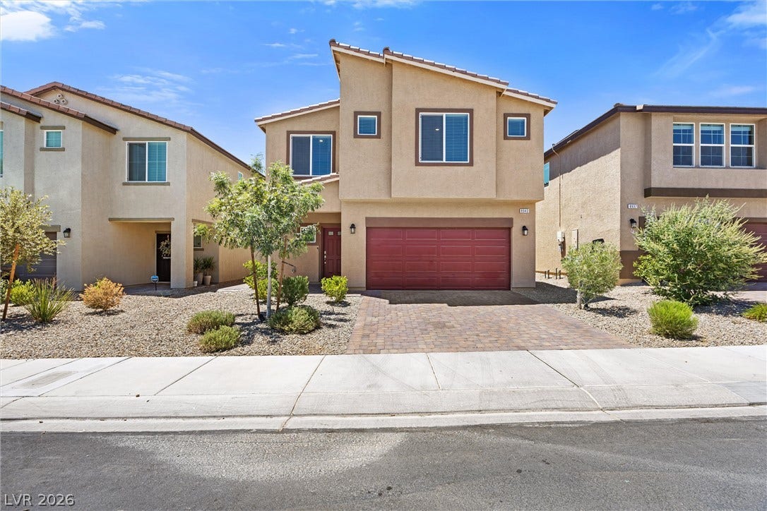 8943 Pelican Point Street, Las Vegas, NV 89178 A contemporary stucco residence with a brick paver driveway and desert-friendly landscaping.